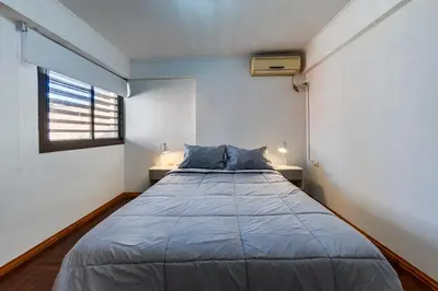 a large bed in a room with a window at Calasanz in Cordoba