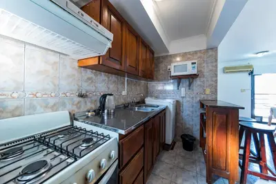 a kitchen with a stove and a sink at Calasanz in Cordoba