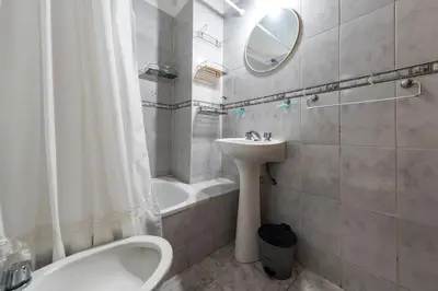 a bathroom with a sink and a tub and a mirror at Calasanz in Cordoba