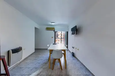 a kitchen with a table and a chair in a room at Calasanz in Cordoba