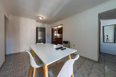 a dining room with a white table and chairs at Calasanz in Cordoba