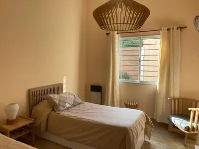a bedroom with a bed and a window at Casa Ayacucho in Alta Gracia