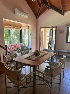 a living room with a wooden table and chairs at El Recuerdo in Merlo