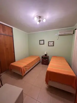 a room with two beds in a room at El Recuerdo in Merlo