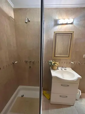 a bathroom with a shower and a sink and a tub at El Recuerdo in Merlo