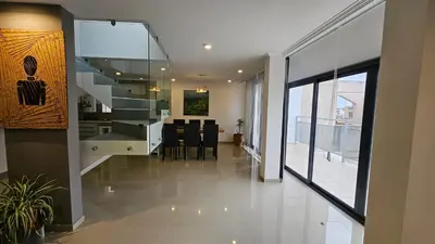 a kitchen and dining room with a staircase in a house at Penthouse Calazans in Cordoba