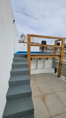 a set of stairs with a railing on a roof at Penthouse Calazans in Cordoba