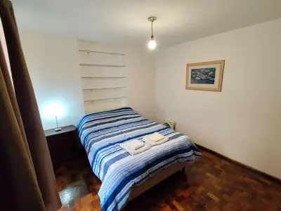 a bedroom with a bed with two towels on it at Balcarce Residential Apartament in Cordoba