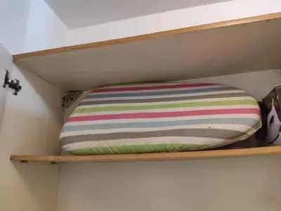 a pillow on a shelf in a closet at Balcarce Residential Apartament in Cordoba