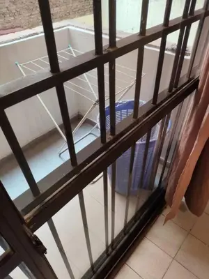 a metal cage with a dishwasher in a room at Balcarce Residential Apartament in Cordoba