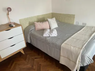 a bedroom with a bed with two pillows and a dresser at A metros de PATIO OLMOS in Cordoba