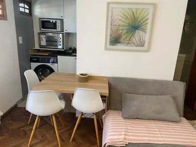 a kitchen with a table and two chairs and a dining room at A metros de PATIO OLMOS in Cordoba