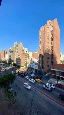 a city with cars parked on a street with tall buildings at A metros de PATIO OLMOS in Cordoba