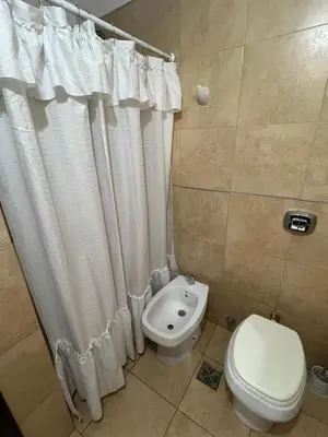 a bathroom with a toilet and a bidet at Departamento céntrico en Córdoba in Cordoba