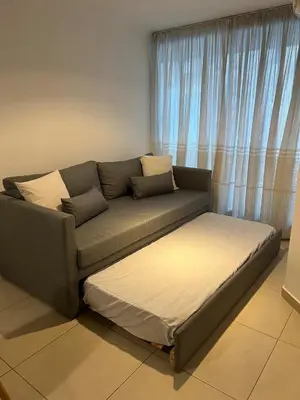 a couch sitting in a living room next to a window at Departamento céntrico en Córdoba in Cordoba