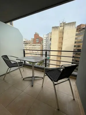 a table and chairs on a balcony with a view at Departamento céntrico en Córdoba in Cordoba
