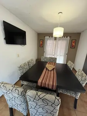 a dining room with a black table and chairs at Complejo con seguridad in Cordoba