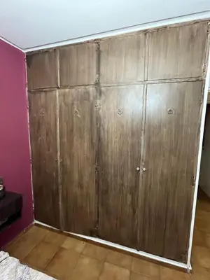 a closet with wooden doors in a room at Complejo con seguridad in Cordoba