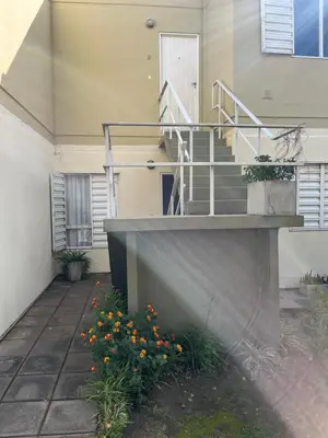 a house with a staircase and flowers in the yard at Complejo con seguridad in Cordoba