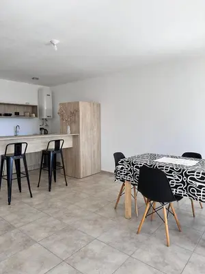a kitchen with a table and chairs in a room at Departamento Estrada Lux Céntrico in Villa Carlos Paz