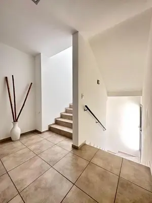 an empty room with stairs and a vase on the floor at Departamento Estrada Lux Céntrico in Villa Carlos Paz