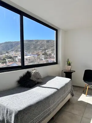 a bedroom with a bed and a large window at Departamento Estrada Lux Céntrico in Villa Carlos Paz