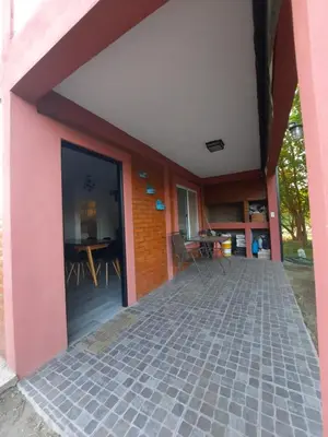 a patio of a house with a table and chairs at Cabañas Las abuelas in Villa Rumipal
