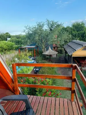 a wooden bench sitting on top of a deck at Cabañas Las abuelas in Villa Rumipal