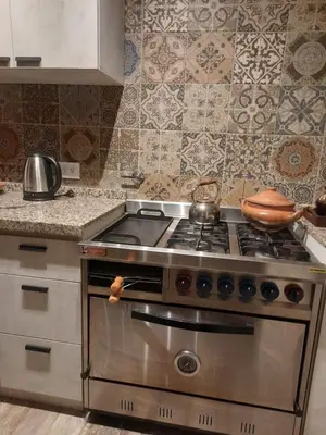a kitchen with a stove with a pot on it at Mirada al Champaquí - Chalet de Montaña in Villa Yacanto