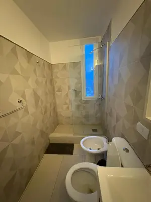 a bathroom with a toilet and a sink at Exclusivo depto en Complejo Santo Domingo con seguridad 24 hs in Cordoba
