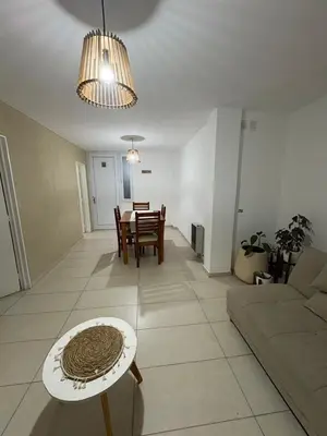a living room and dining room with a couch and a table at Exclusivo depto en Complejo Santo Domingo con seguridad 24 hs in Cordoba