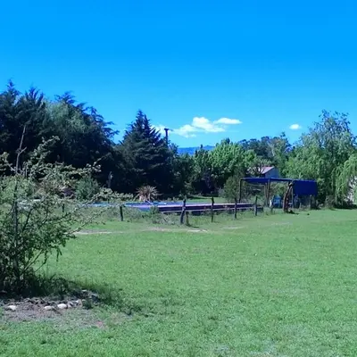 a park with a bench and a gazebo at Cabanas Parparim in Mina Clavero