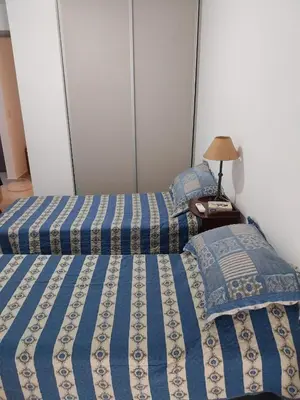 two beds sitting next to each other in a bedroom at Departamento en Edificio Fluss, Mariano Fragueiro 585 in Cordoba