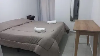 a bed with a white towel on top of it at Departamento en Edificio Fluss, Mariano Fragueiro 585 in Cordoba