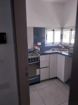 a kitchen with a stove and a sink at Departamento en Edificio Fluss, Mariano Fragueiro 585 in Cordoba