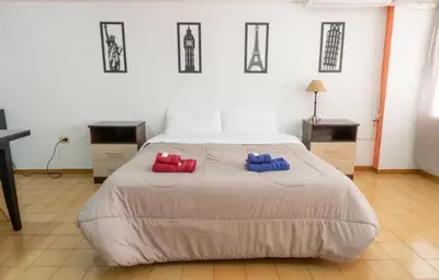 a bedroom with a bed with two pillows on it at Departamento Bv Chacabuco by INMOVE Temporarios in Cordoba