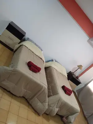 a bed with two pillows on it in a room at Departamento Bv Chacabuco by INMOVE Temporarios in Cordoba