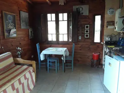 a kitchen with a table and chairs in a room at Alpa'y Kanki in Alpa Corral