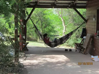 a man laying in a hammock in a porch at Alpa'y Kanki in Alpa Corral
