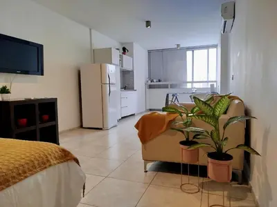 a living room with a couch and a refrigerator at Monoambiente excelente ubicación Cordoba Rent in Cordoba