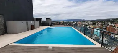 a swimming pool on the roof of a building at Miralejos 7 Music in Villa Carlos Paz