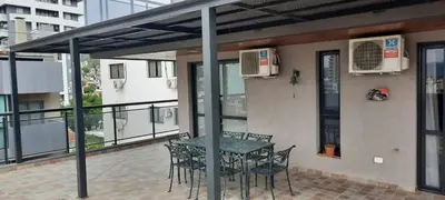 a patio with a table and chairs on a balcony at Miralejos 7 Music in Villa Carlos Paz