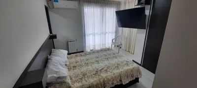 a bedroom with a bed and a large window at Miralejos 7 Music in Villa Carlos Paz