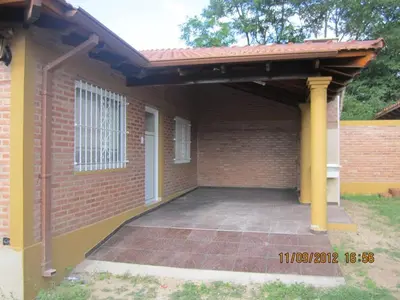 a patio with awning on a brick house at Duplex de la Virgen in Mina Clavero