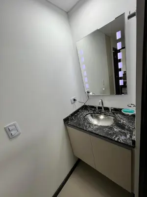 a bathroom with a sink and a mirror at departamento complejo Veneto Village con vista al lago in Villa Parque Siquiman