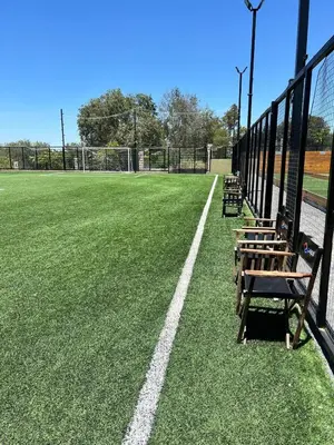 a row of benches sitting on a baseball field at departamento complejo Veneto Village con vista al lago in Villa Parque Siquiman