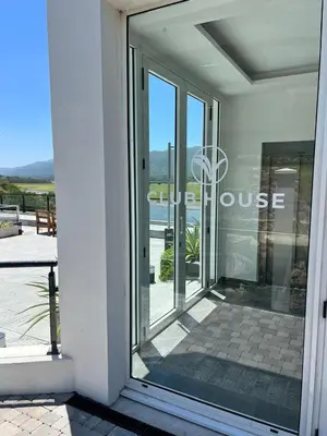a glass door to a house with a basketball hoop at departamento complejo Veneto Village con vista al lago in Villa Parque Siquiman