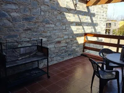 a patio with a table and chairs and a brick wall at Paraíso Serrano 6 in Villa Ciudad Parque