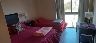 a room with two beds and a window at Paraíso Serrano 6 in Villa Ciudad Parque
