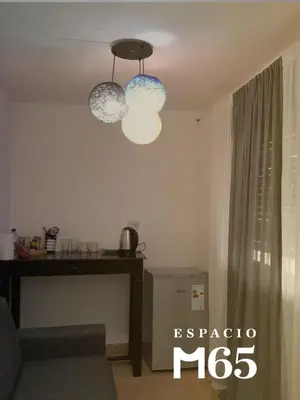 a living room with two lights hanging from the ceiling at M65 Luxury Suit in Cordoba